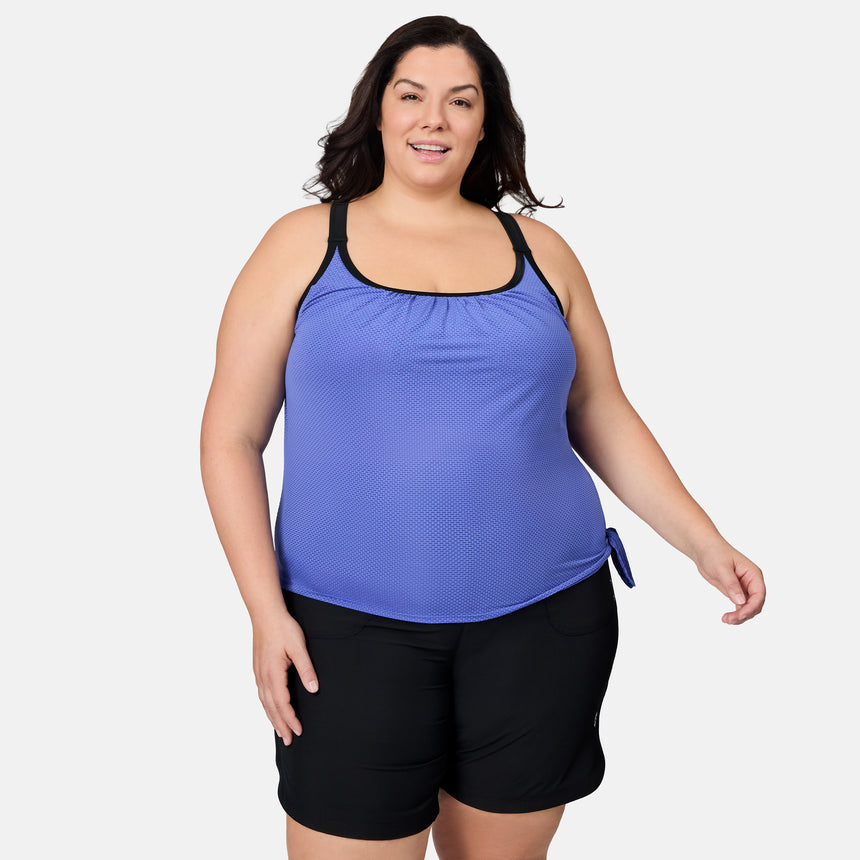 [Melissa is 5'10" wearing size 1X] Woman wearing a blue tank top and black shorts on a white background