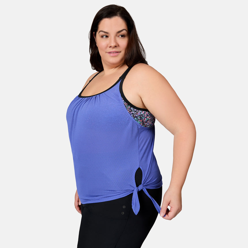 [Melissa is 5'10" wearing size 1X] Woman wearing a blue tank top with black trim on a white background