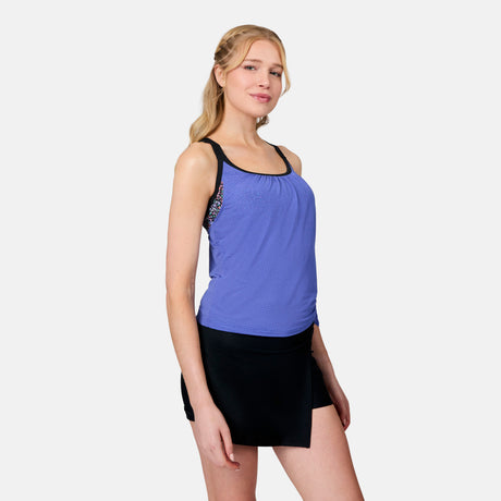 [Emily is 5'10" wearing size S] Woman wearing a blue athletic tank top and black skirt on a white background