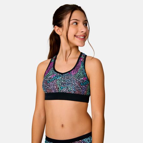 [Model is wearing a size Medium.] Girl wearing the Free Country Girls' Fresco Rash Guard and Bikini Swim Set in Black Fresco, size M, featuring a raglan sleeve rash guard and racerback tankini top and lined bikini bottom made from recycled polyester fabric that provides four way stretch and upf protection #color_ Black-Fresco