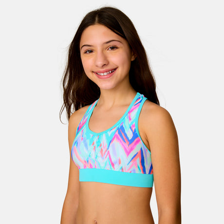 [Model is wearing a size Medium.] Girl wearing the Free Country Girls' Fresco Rash Guard and Bikini Swim Set in Aquatopia Oasis Chevron, size M, featuring a raglan sleeve rash guard and racerback tankini top and lined bikini bottom made from recycled polyester fabric that provides four way stretch and upf protection #color_ Aquatopia-Oasis-Chevron