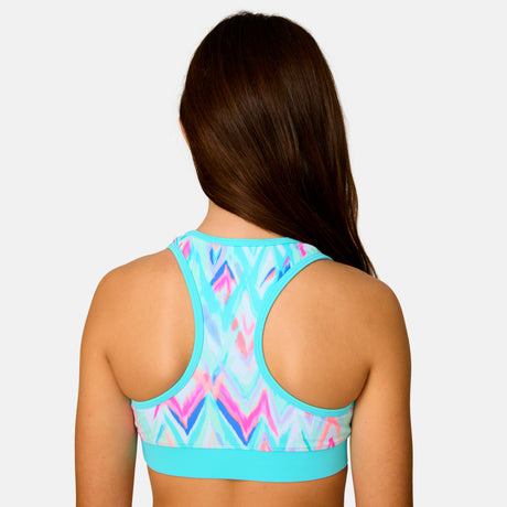 [Model is wearing a size Medium.] Girl wearing the Free Country Girls' Fresco Rash Guard and Bikini Swim Set in Aquatopia Oasis Chevron, size M, featuring a raglan sleeve rash guard and racerback tankini top and lined bikini bottom made from recycled polyester fabric that provides four way stretch and upf protection #color_ Aquatopia-Oasis-Chevron