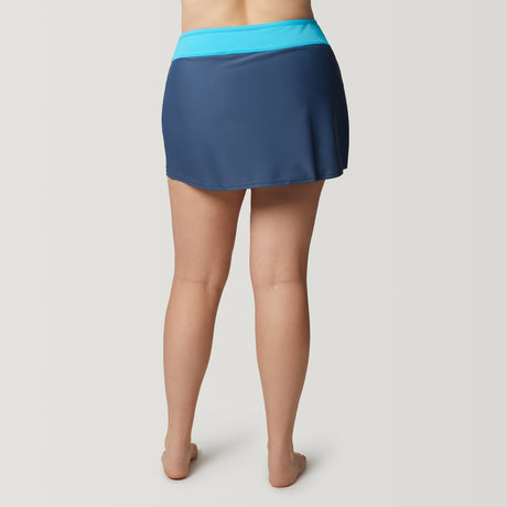 A woman stands barefoot, facing away, wearing the Clearance Women's Plus Size Drawstring Swim Skirt with a light blue waistband and quick-dry fabric, set against a plain light background.