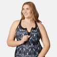A woman with long, light brown hair smiles to the side, wearing the Clearance Women's Plus Size Tango Mesh Zip Up Racerback Tankini Top. The quick-drying UPF 50+ fabric is perfect for sunny days. Background is plain white.