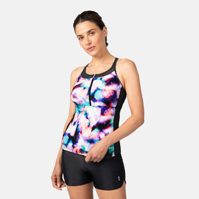 [Olga is 5'10" wearing a size S.] Woman wearing a colorful tank top and black shorts on a white background