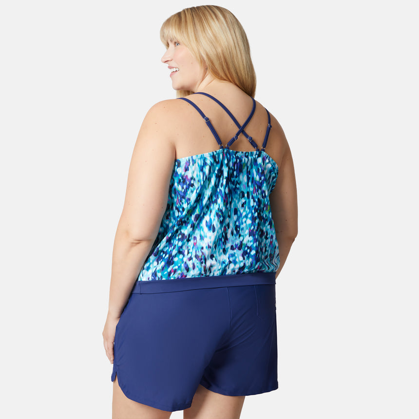 [Lola is 5'10" wearing size 1X] Woman wearing a blue patterned top and navy shorts on a white background