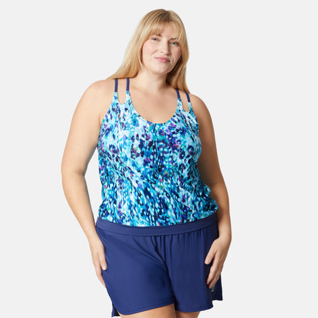 [Lola is 5'10" wearing size 1X] Woman wearing a blue floral tank top and navy shorts on a white background