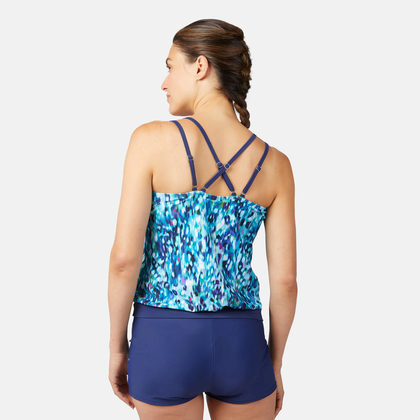 [Olga is 5'10" wearing size S.] Woman wearing a blue and purple patterned tankini top and navy swim shorts on a white background