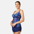 [Olga is 5'10" wearing size S.] Woman wearing a colorful blue tankini top and navy blue skirt on a white background