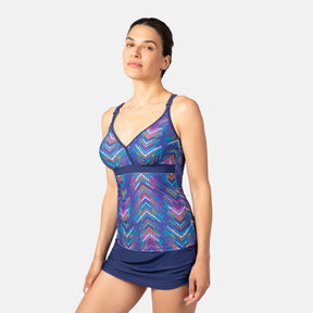 [Olga is 5'10" wearing size S.] Woman wearing a colorful blue tankini top and navy blue skirt on a white background