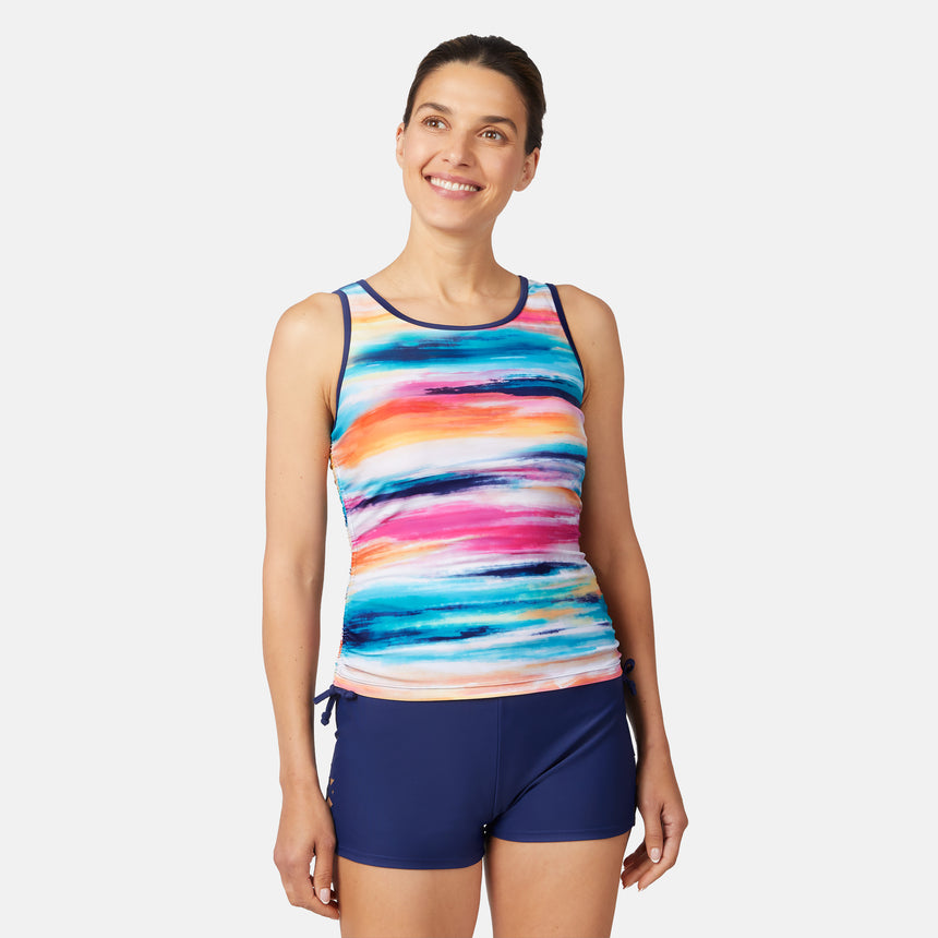 [Olga is 5'10" wearing size S.] Woman wearing a colorful striped tank top and navy shorts on a white background