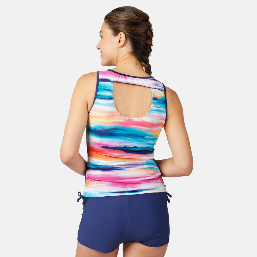 [Olga is 5'10" wearing size S.] Woman wearing a colorful striped tank top and navy shorts on a white background