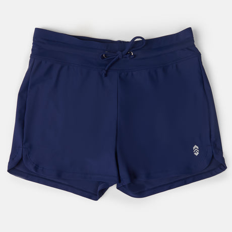Free Country Women's Drawstring Swim Short in navy blue with a drawstring waist, small white logo on the lower left leg, and quick dry fabric, shown laid flat on a white background.