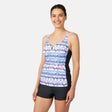 [Olga is 5'10" wearing size S.] Woman wearing a colorful periwinkle tankini top and black shorts on a white background