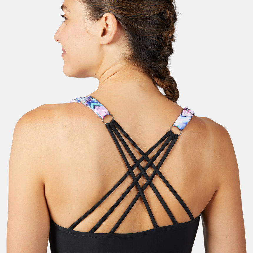 [Olga is 5'10" wearing size S.] Woman wearing a colorful periwinkle tankini top with black criss-cross straps on a white background