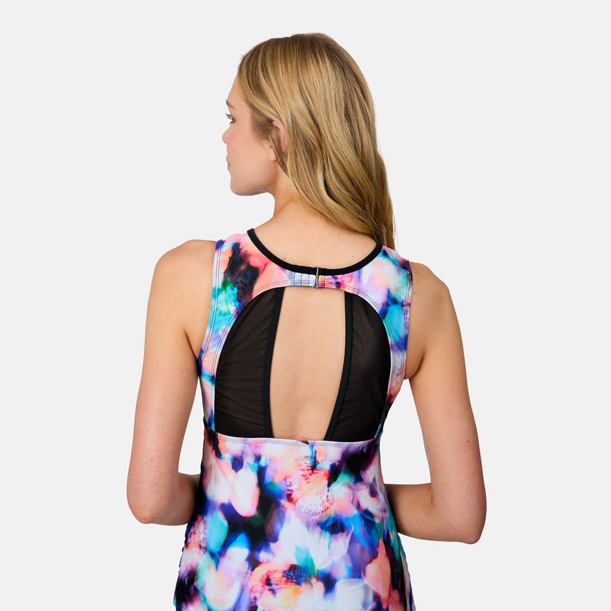 [Emily is 5'10" wearing size S] Woman wearing a colorful dress with a black open-back design on a light gray background