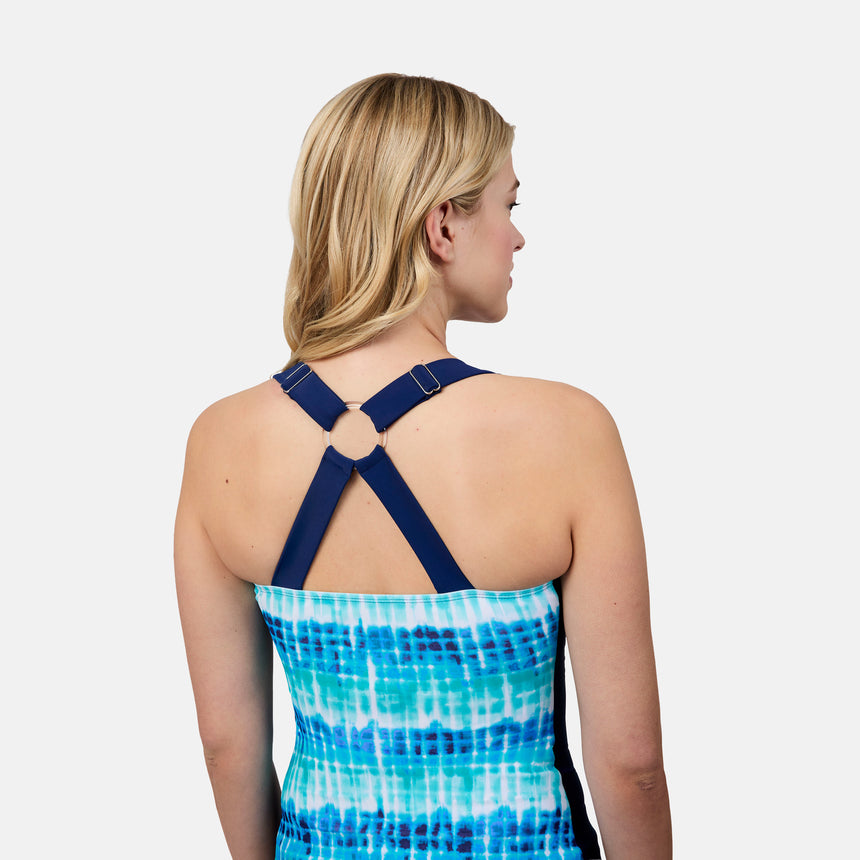 [London is 5'9.5" wearing size S] Woman wearing a blue and white patterned dress with criss-cross straps on a plain background