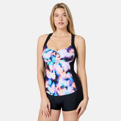 [London is 5'9.5" wearing size S] Woman wearing a colorful tank top with black shorts on a white background