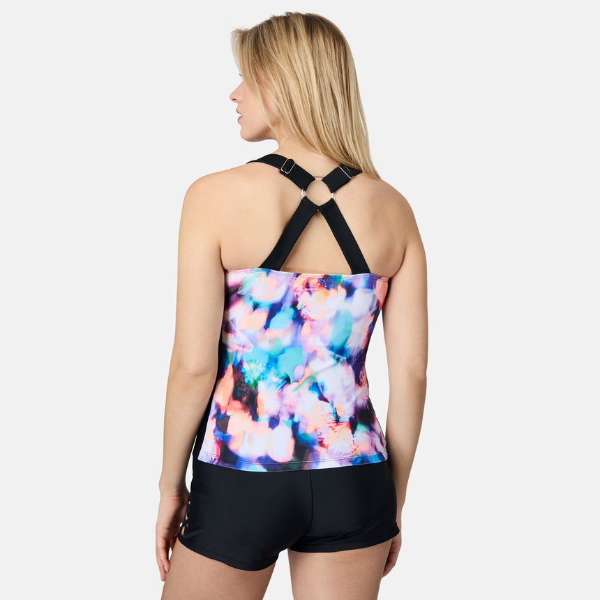 [London is 5'9.5" wearing size S] Woman wearing a colorful tank top with black straps and black shorts on a white background