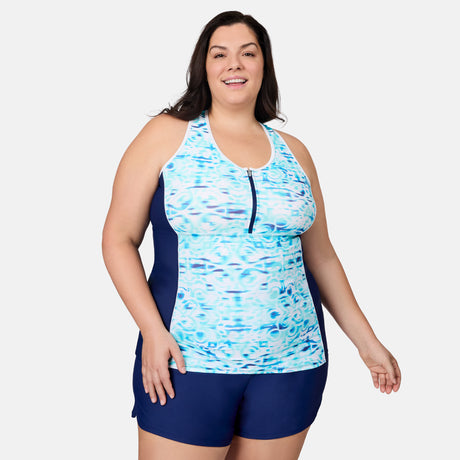 [Melissa is 5'10" wearing size 1X] Woman wearing a blue and white patterned tank top and navy shorts on a white background