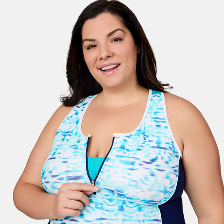 [Melissa is 5'10" wearing size 1X] Woman wearing a blue and white patterned tankini top with a plain background