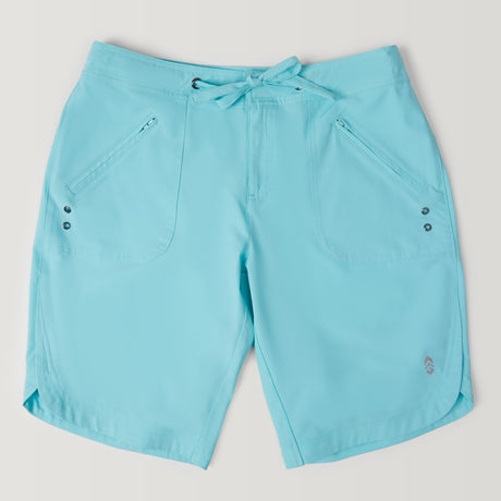 The Women's Bermuda Board Short II features a light blue color, front zippered pockets, a lace-up waistband with metallic grommets, and quick-dry fabric. Shown laid flat on a white background.