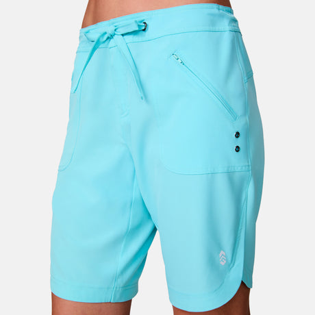 A close-up of a person wearing the Women's Bermuda Board Short II, featuring a drawstring waist, front pockets, a small logo near the left hem, and made from quick-drying fabric for all-day comfort.