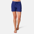 [Model is wearing a size Small.] Woman wearing Free Country Women's 5" Bermuda Board Short in Marine, size S, made from quick drying UPF stretch performance fabric featuring a fly front zipper closure with a drawcord and two front pockets 