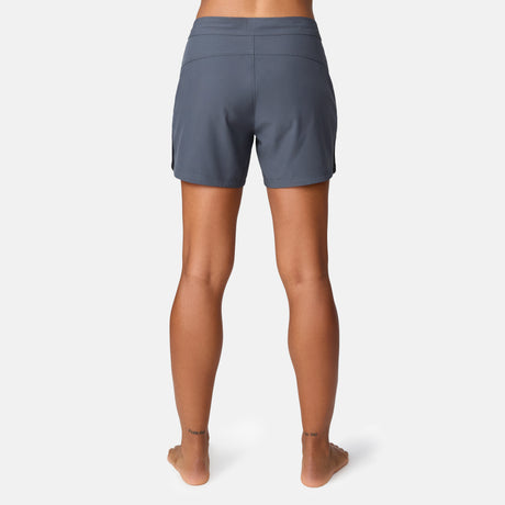 [Model is wearing a size Small.] Woman wearing Free Country Women's 5" Bermuda Board Short in Shadow, size S, made from quick drying UPF stretch performance fabric featuring a fly front zipper closure with a drawcord and two front pockets 