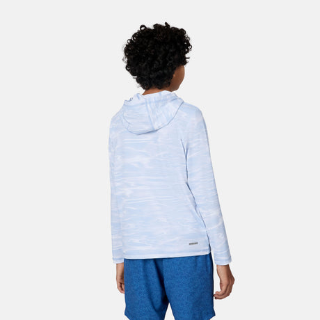 A child with curly hair, dressed in the Free Country Kids' Everybody SunFree UPF Hoodie in light blue and blue shorts, stands facing away against a plain white background.