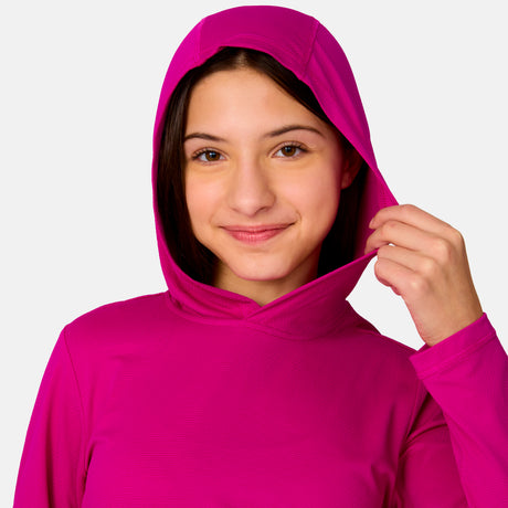 [Model is wearing a size Medium.] Girl wearing Free Country The Kids' Everybody SunFree UPF Hoodie in Magenta, size M, made from moisture wicking stretch UPF performance fabric featuring an attached hood 