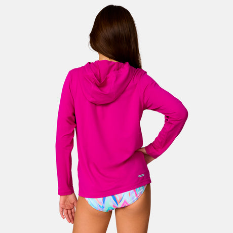 [Model is wearing a size Medium.] Girl wearing Free Country The Kids' Everybody SunFree UPF Hoodie in Magenta, size M, made from moisture wicking stretch UPF performance fabric featuring an attached hood 