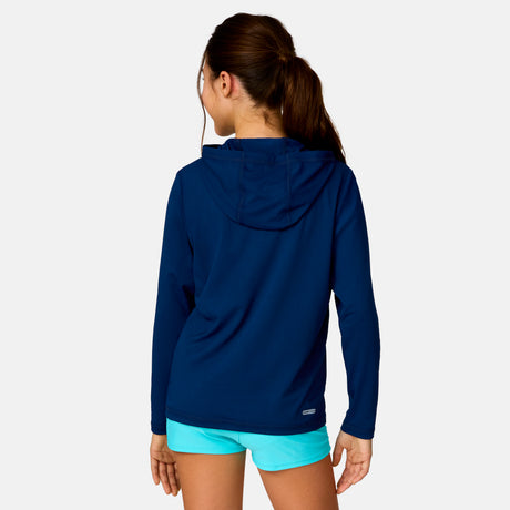 [Model is wearing a size Medium.] Girl wearing Free Country The Kids' Everybody SunFree UPF Hoodie in Navy, size M, made from moisture wicking stretch UPF performance fabric featuring an attached hood 