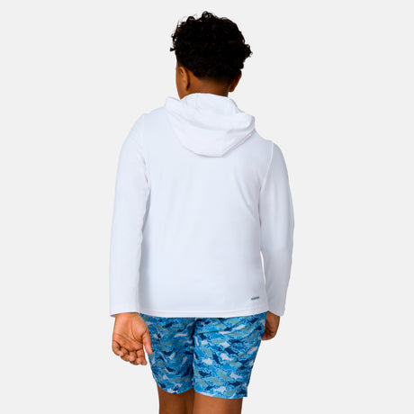 A child with short curly hair is shown from behind, wearing the Free Country Kids' Everybody SunFree UPF Hoodie in white and blue patterned shorts, standing against a plain white background.