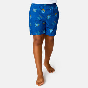 [Model is wearing a size Medium.] Boy wearing the Free Country Boys' Sunset Voyage Swim Short in Blue Sunset Voyage, size M, featuring recycled polyester fabric and elastic waistband and upf protection, paired with white sunshirt #color_ Blue-Sunset-Voyage