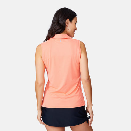 A woman with long brown hair faces away from the camera, wearing a Free Country Women's SunFree Sleeveless Top and a short black skirt against a plain white background.