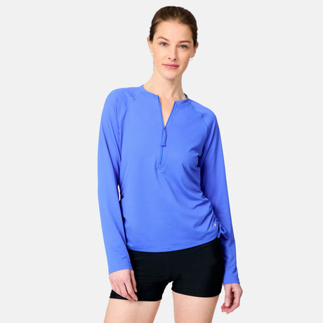 [Kaitlyn is 5'9" wearing size S.] Woman wearing a blue long-sleeve top and black shorts on a white background