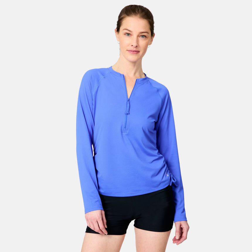 [Kaitlyn is 5'9" wearing size S.] Woman wearing a blue long-sleeve top and black shorts on a white background