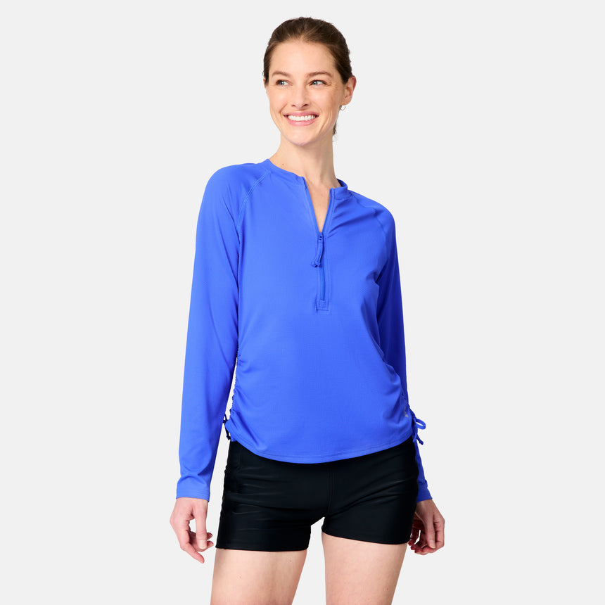 [Kaitlyn is 5'9" wearing size S.] Woman wearing a blue long-sleeve top and black shorts on a white background
