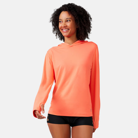 [Victoria is 5'10" wearing a size Small.] Woman wearing Free Country The Everybody SunFree UPF Hoodie in Papaya, size M, made from moisture wicking stretch UPF performance fabric featuring  an attached hood 