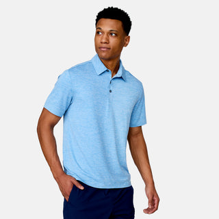 [Josiah is 6'3" wearing a size Medium.] Man wearing Free Country Men's SunFree UPF Polo Shirt in Blue, size M, made from anti-odor, breathable lightweight recycled polyester performance fabric featuring a classic active fit, styled with black shorts #color_blue