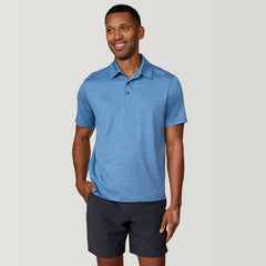 [Anderson is 6'2" wearing a size Medium.] Man wearing Free Country Men's SunFree UPF Polo Shirt in Wave, size M, made from anti-odor, breathable lightweight recycled polyester performance fabric featuring a classic active fit, styled with black shorts #color_wave