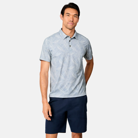 [Scott is 6’3" wearing size M] Man wearing a light blue patterned polo shirt and navy shorts on a white background