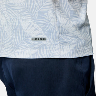 [Scott is 6’3" wearing size M] Close-up of a person wearing a light blue patterned shirt with navy pants on a plain background