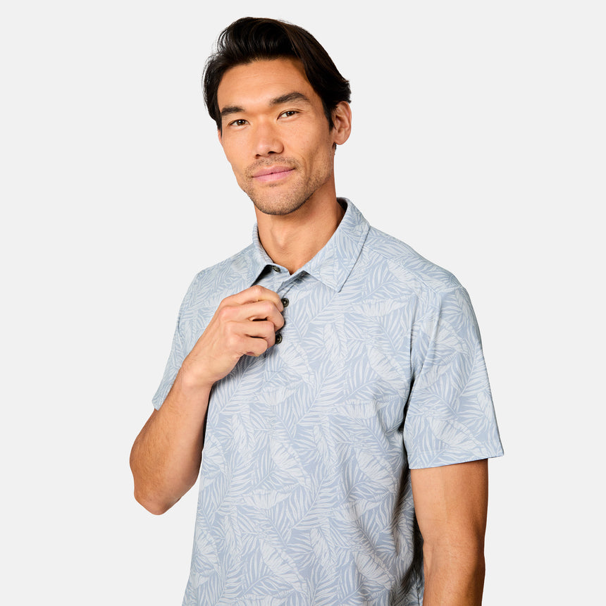 [Scott is 6’3" wearing size M] Man wearing a light blue patterned polo shirt and navy shorts on a white background