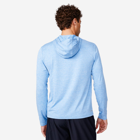 A man with short curly hair is seen from behind, wearing the Free Country Men's Textured SunFree UPF Hoodie in light blue and dark shorts, standing against a plain white background.