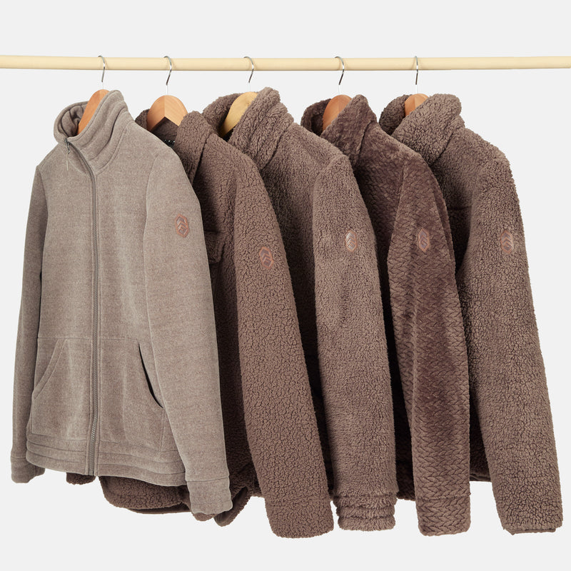 Row of brown fleece jackets on hangers against a white background