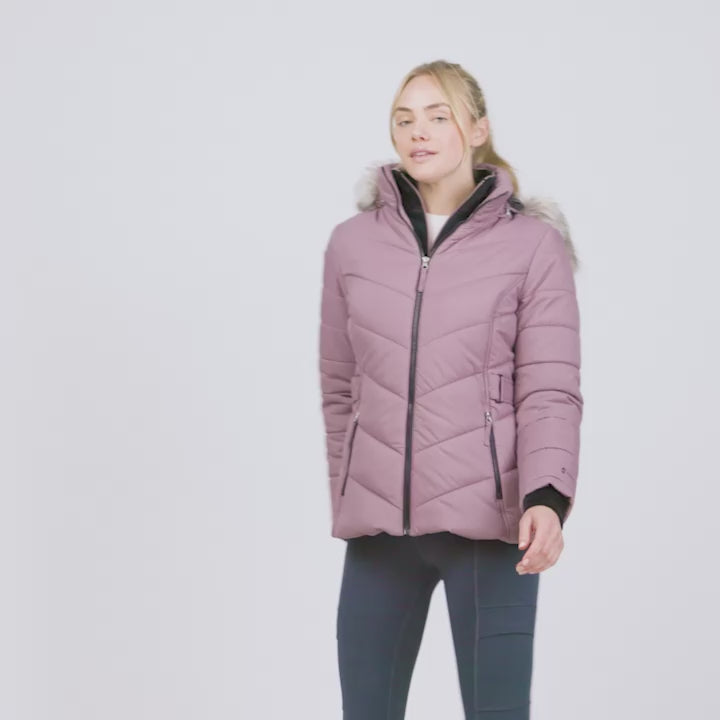 Model wearing the Women's Unstoppable II Poly Air Touch Jacket in dusty pink with a fur-trim hood modeling its various features like attached bib, removable hood and zipper pockets