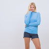 Woman wearing Free Country The Everybody SunFree UPF Hoodie made from moisture wicking stretch UPF performance fabric featuring an attached hood 