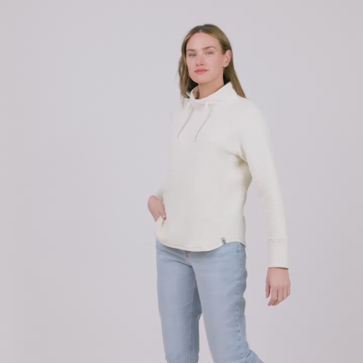 Model wearing the Women's UltraFill Cowl Neck Top in cream, worn with light jeans